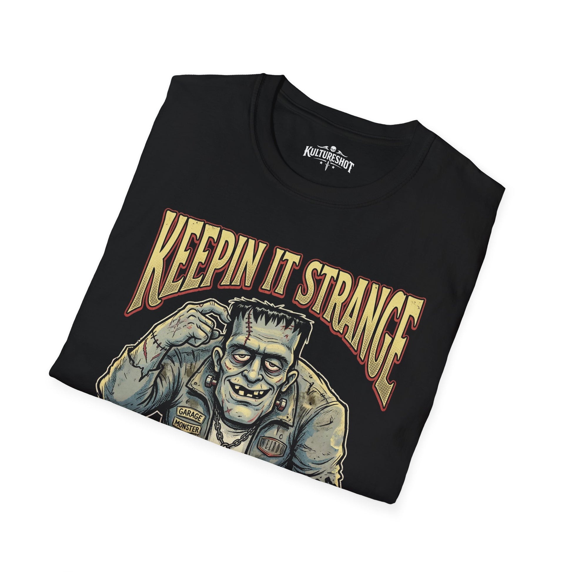Black t-shirt with a graphic design of a creature and 'Keepin It Strange' text on a white background