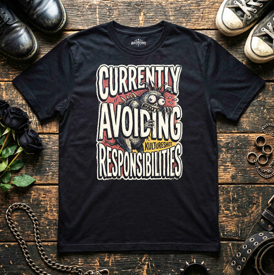 Black t-shirt with graphic design and text on a wooden surface with shoes and chains.