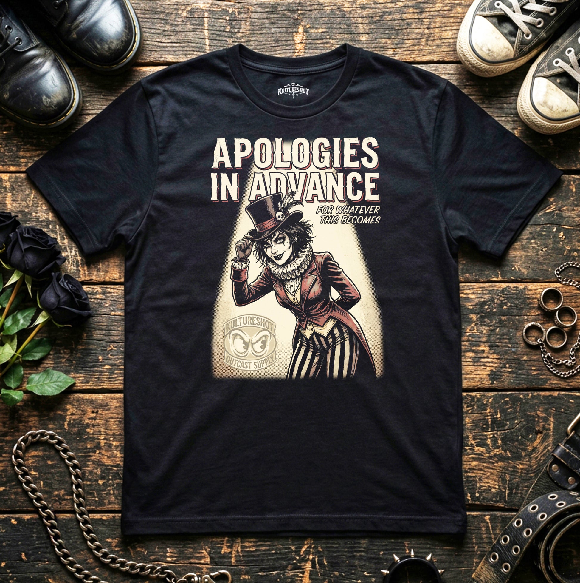 Black t-shirt with graphic design and text on a wooden surface with shoes and roses.