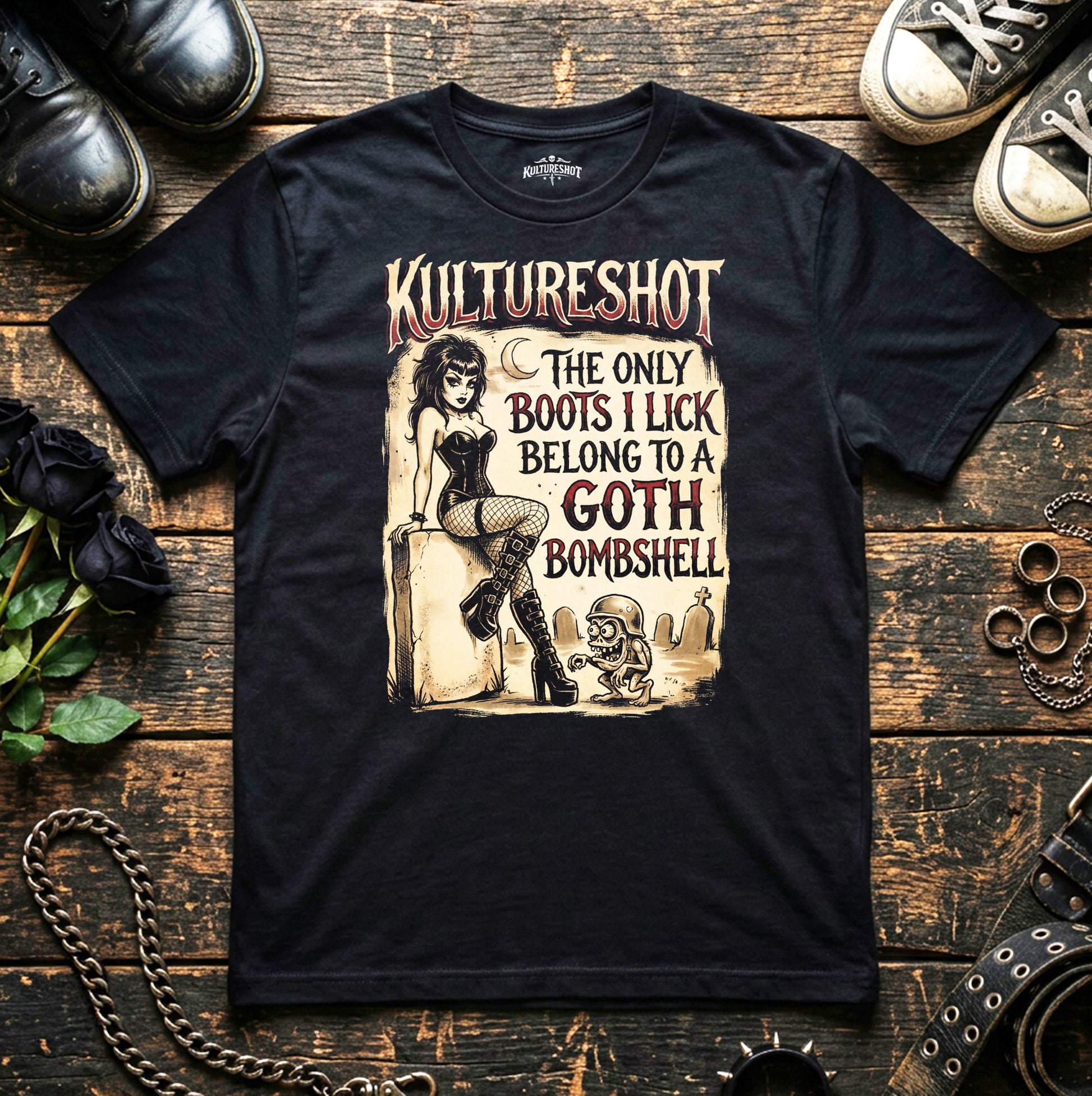 Black t-shirt with graphic design and text on a wooden surface with shoes and roses.