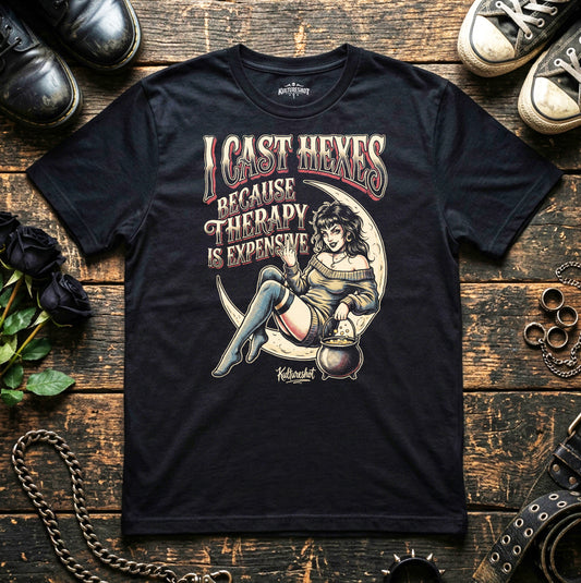 Black t-shirt with graphic design and text on a wooden surface with shoes and decorative items.