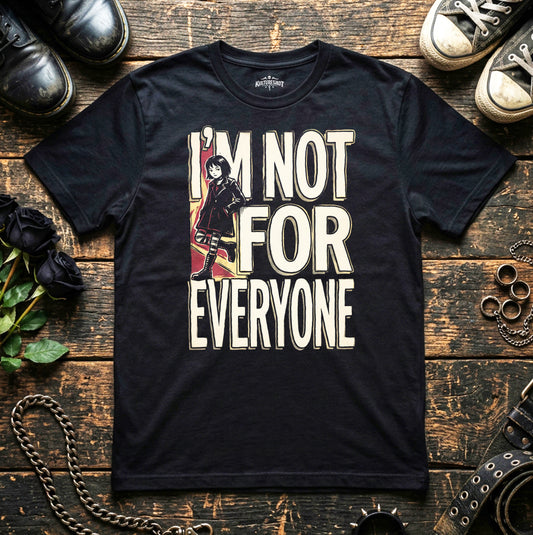 Black t-shirt with graphic design and text on a wooden surface with shoes and accessories.