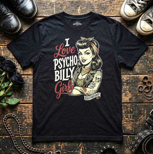 Black t-shirt with graphic design of a woman and text 'I Love Psycho Billy Girls' on a wooden surface with shoes and chains.