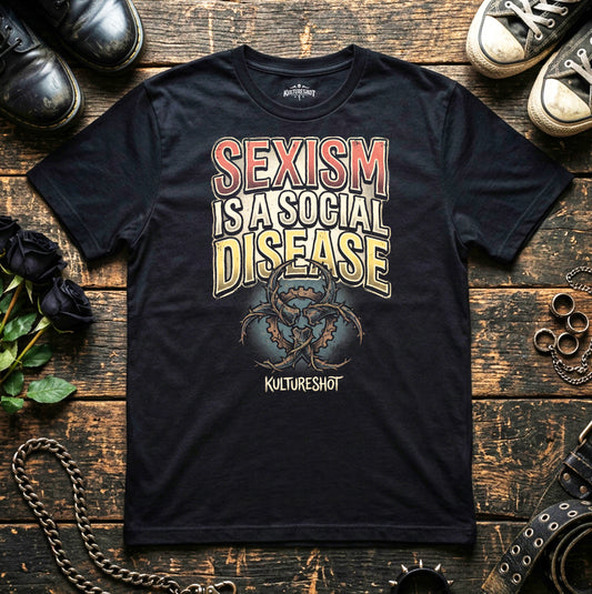 Black t-shirt with 'Sexism is a Social Disease' text on a wooden surface with shoes and roses.