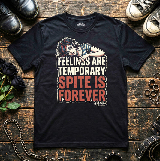 Black t-shirt with a graphic and text on a wooden surface with shoes and flowers.