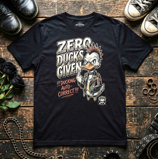 Black t-shirt with a graphic design of a duck and text on a wooden surface with shoes and chains.