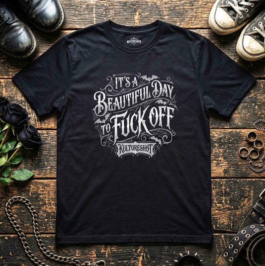 Black t-shirt with graphic text on a wooden surface with shoes and chains.