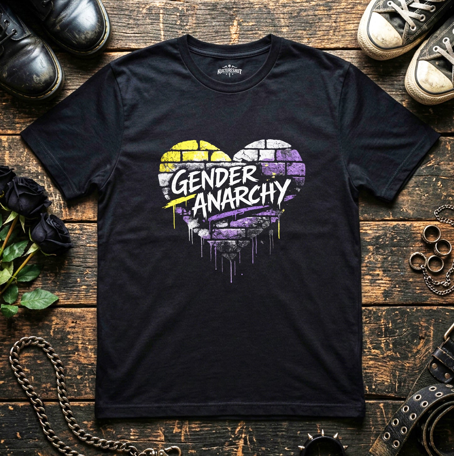 Black t-shirt with 'Gender Anarchy' design on a wooden surface with shoes and chains.