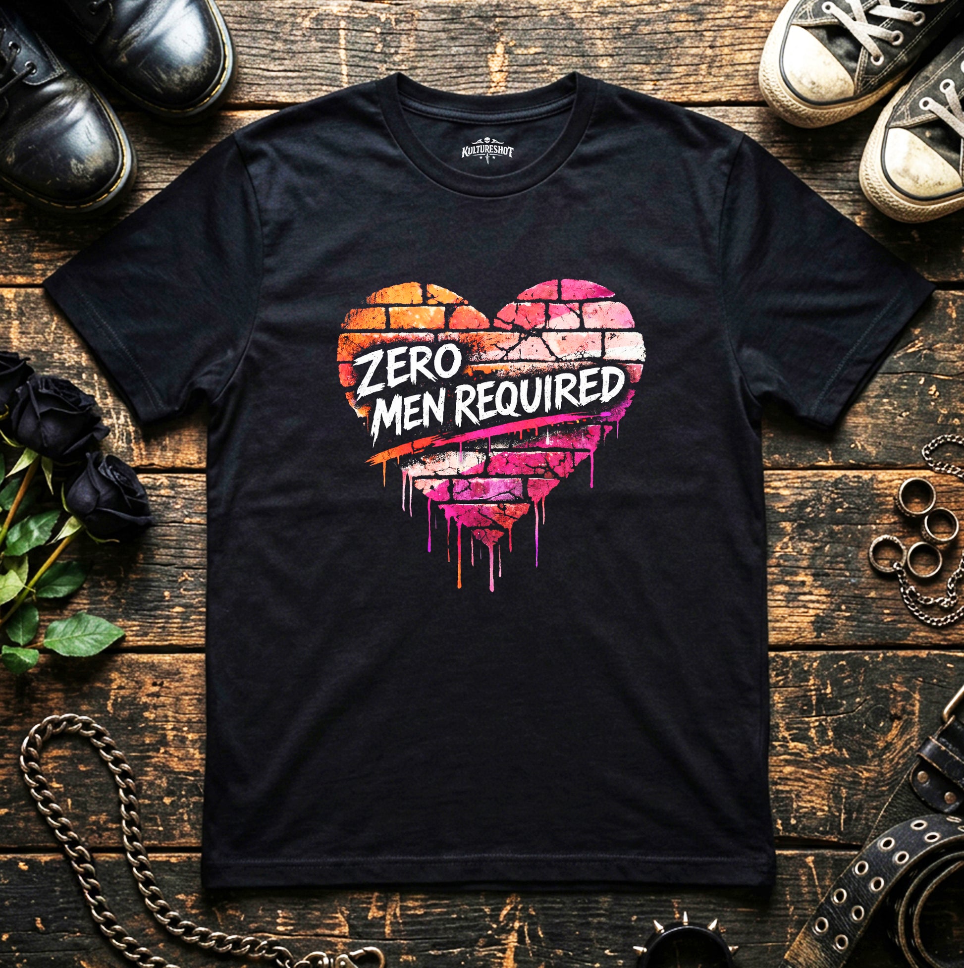 Black t-shirt with colorful heart design and 'Zero Men Required' text on a wooden surface.