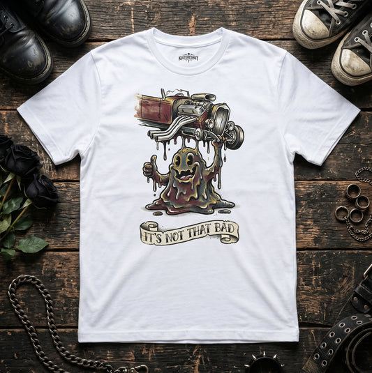 White t-shirt with a graphic design on a wooden surface with shoes and chains.
