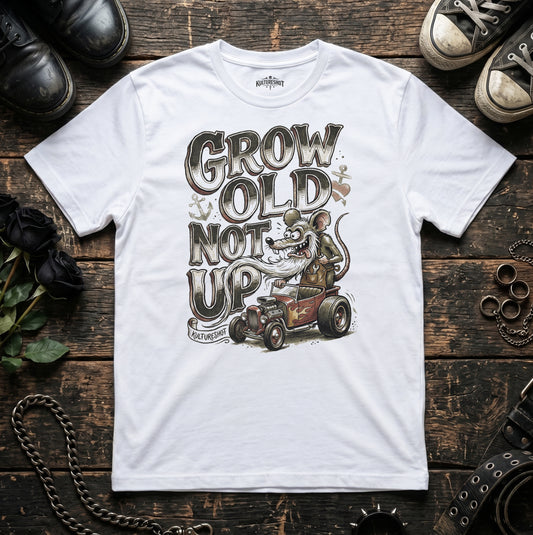 White t-shirt with graphic design and text on a wooden surface with shoes and accessories.