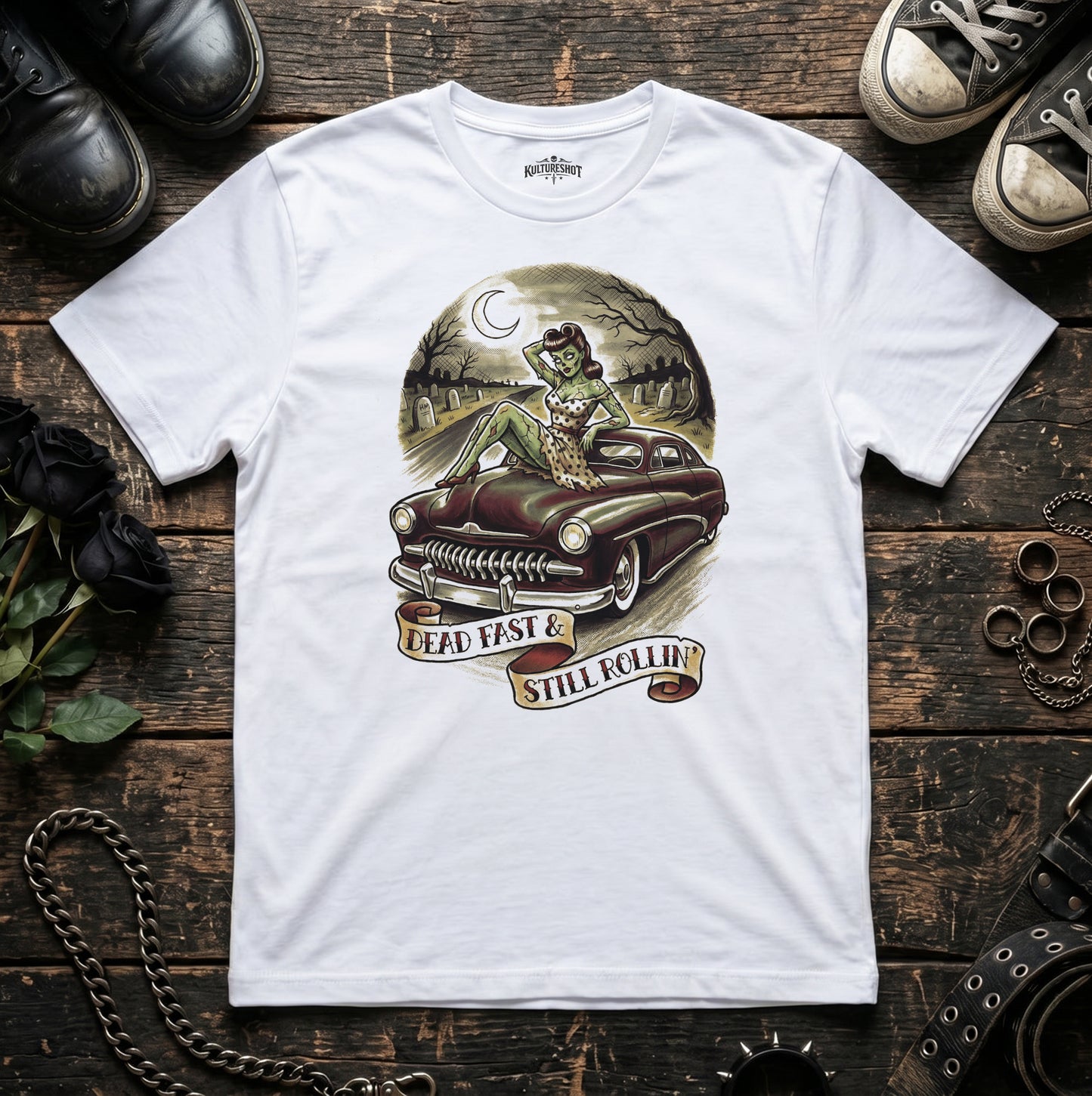 White t-shirt with a graphic design of a car and text on a wooden surface.
