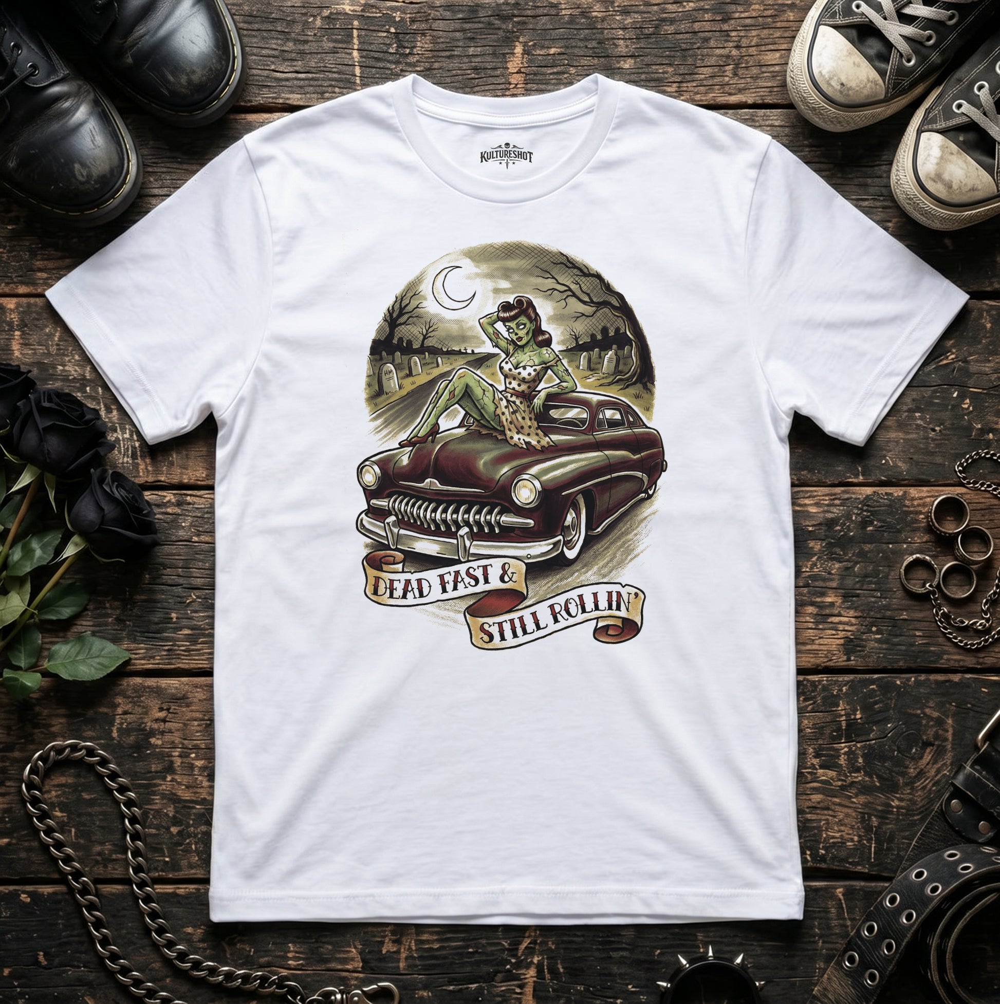 White t-shirt with a graphic design of a car and text on a wooden surface.