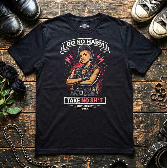 Black t-shirt with graphic design and text on a wooden surface with shoes and roses.