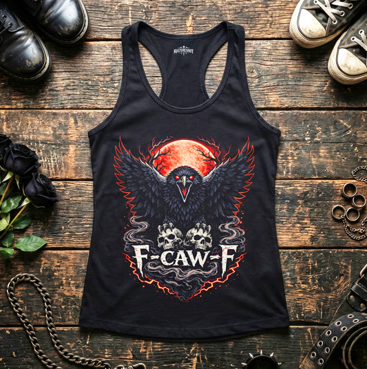 Black tank top with a graphic design on a wooden surface with shoes and accessories.