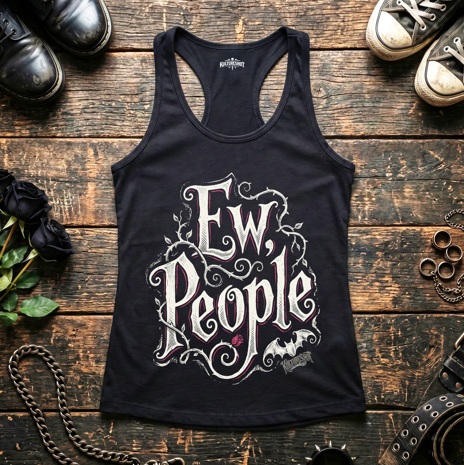 Black tank top with 'Ew, People' text on a wooden surface with shoes and decorative items.