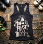 Black tank top with graphic design and text on a wooden surface with shoes and accessories.