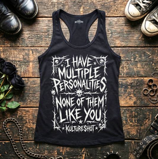 Black tank top with white text on a wooden surface with shoes and accessories.