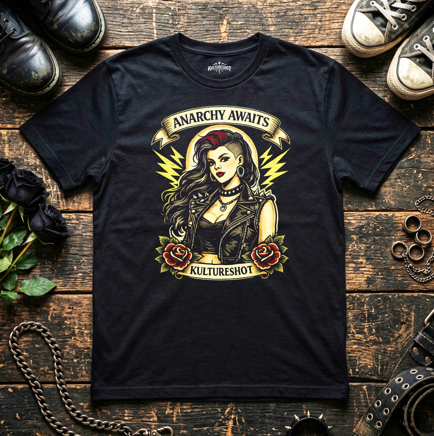 Black t-shirt with graphic design featuring a woman and text 'Anarchy Awaits' on a wooden surface with shoes and roses.