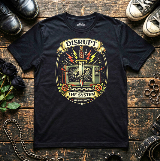 Black t-shirt with graphic design and text on a wooden surface with shoes and flowers.