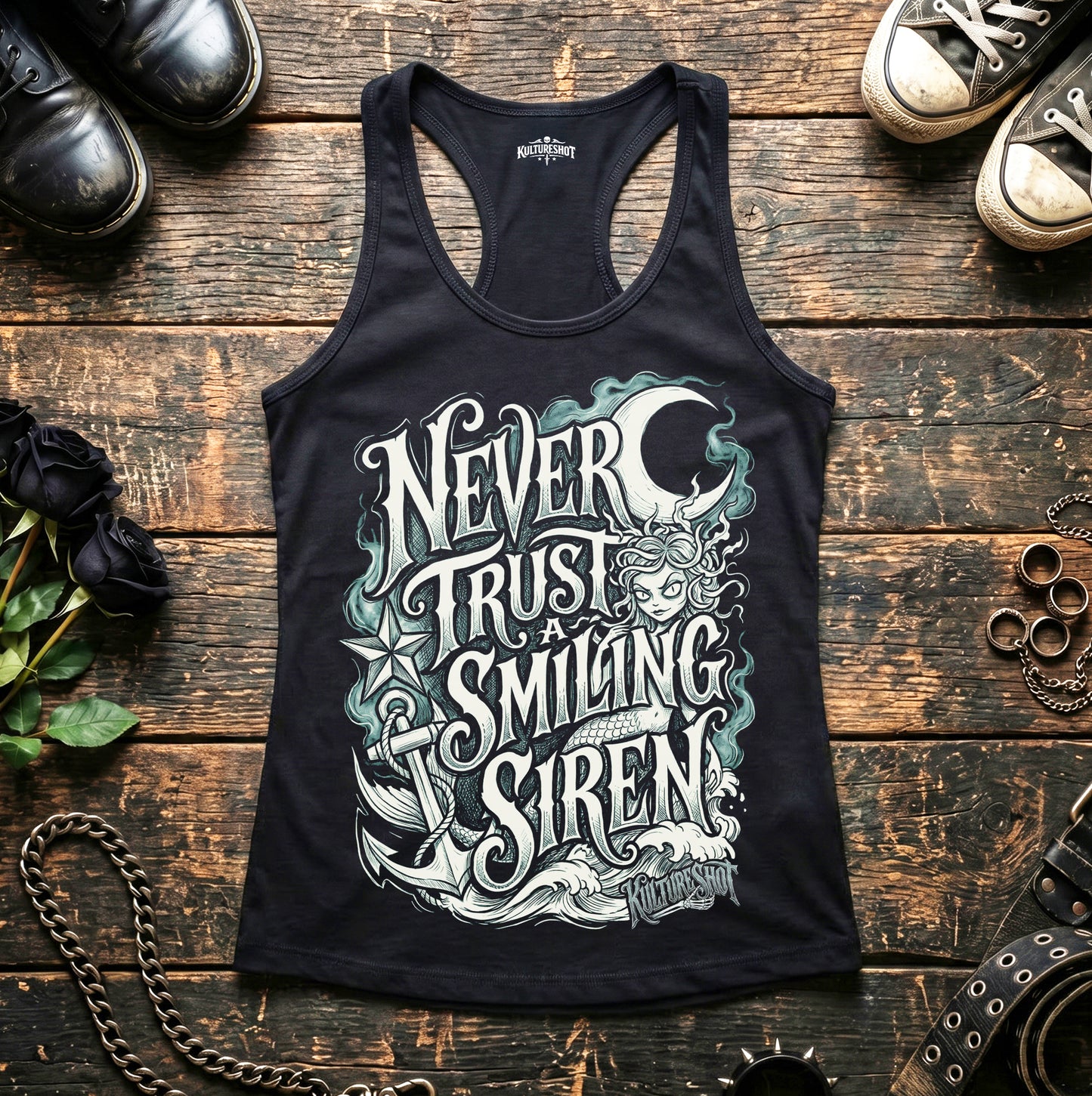 Black tank top with a siren design and text on a wooden surface with shoes and accessories.