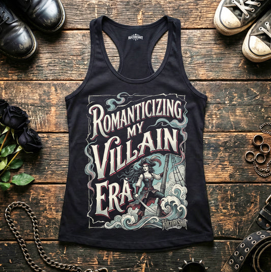 Black tank top with graphic design and text on a wooden surface with shoes and decorative items.